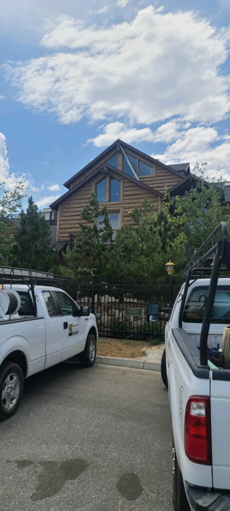 House with pest control trucks in front of it